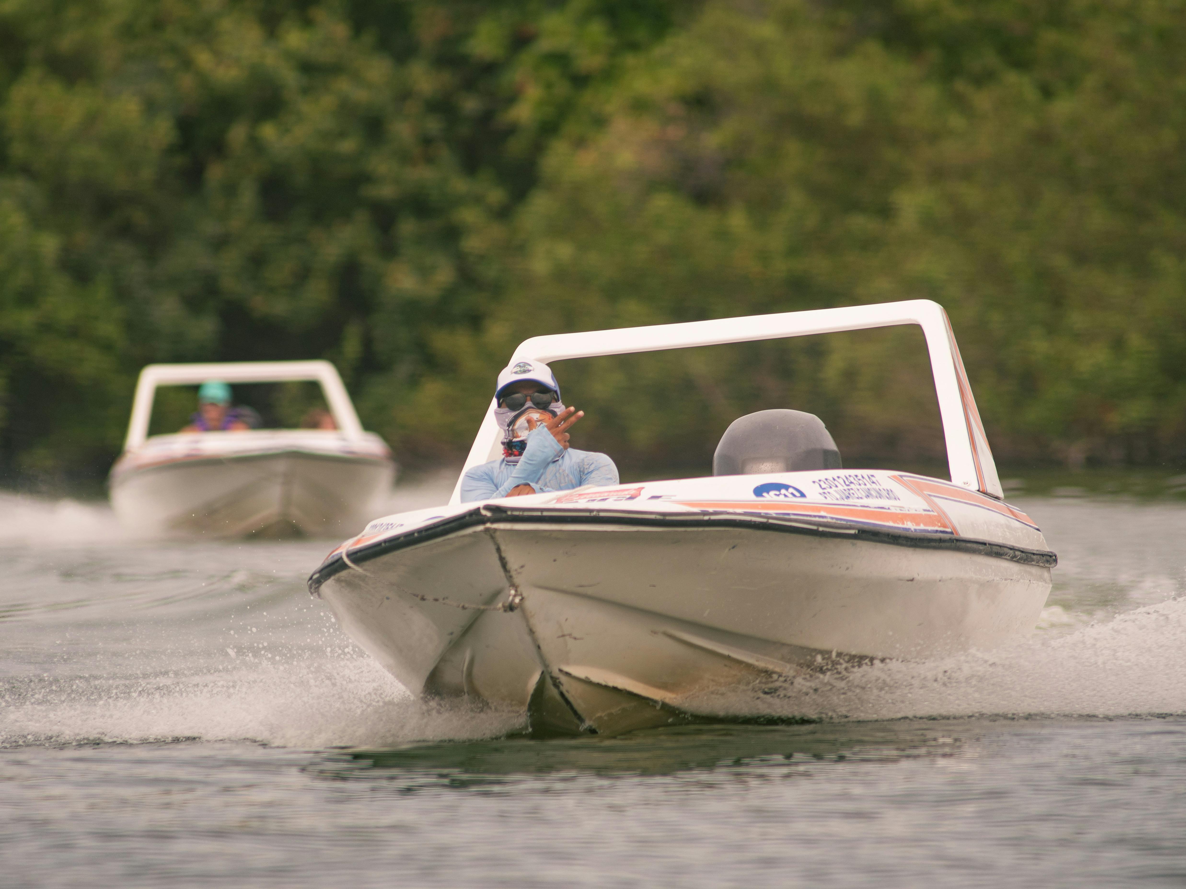 Two speed boats racing swiftly on the waters of Cancun, Mexico, showcasing excitement and adventure.