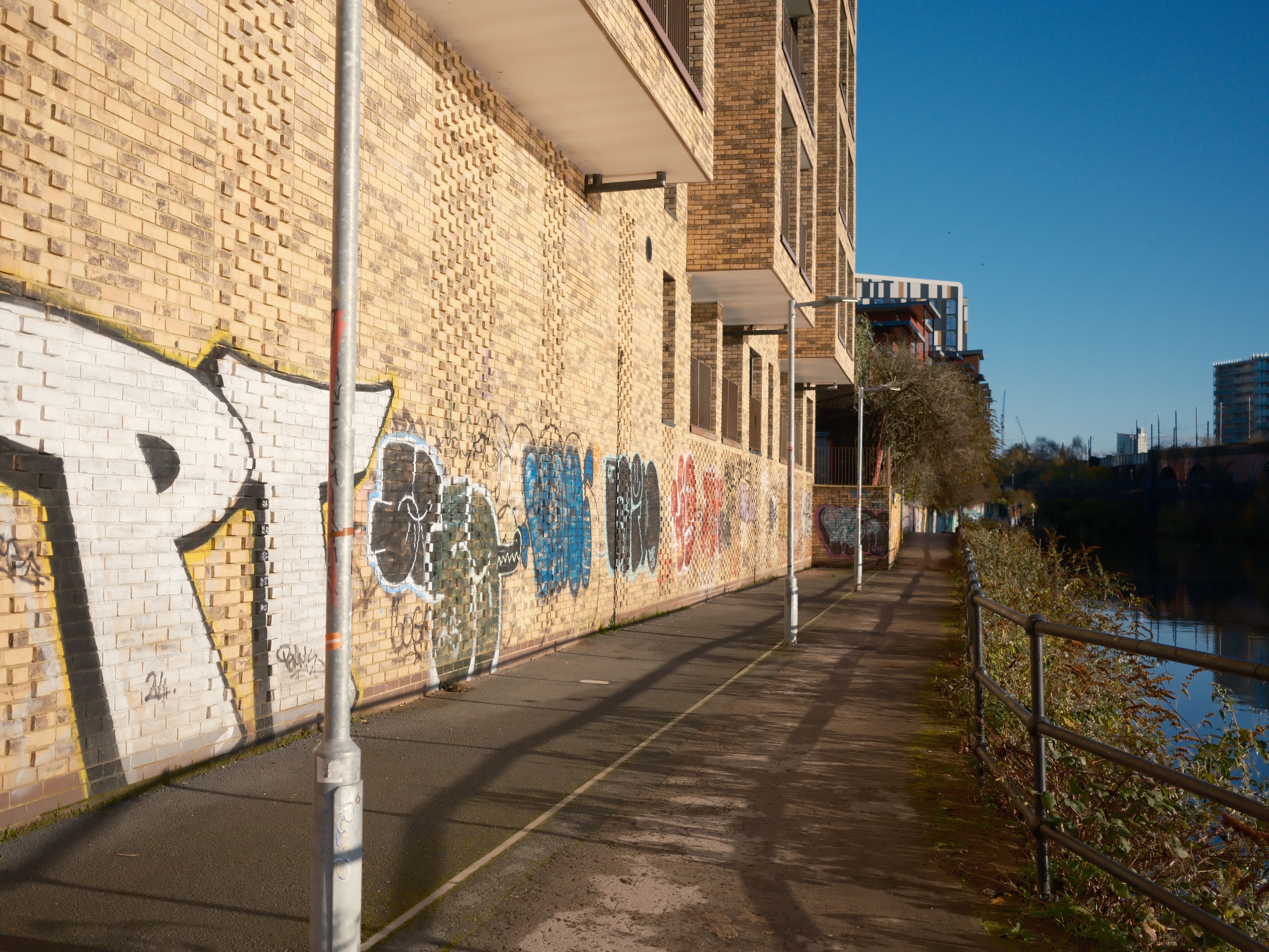 Urban Graffiti on Brick Wall by Riverside · Free Stock Photo