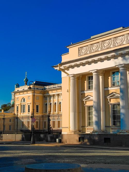 Free Elegant neoclassical building facade under clear blue sky. Stock Photo