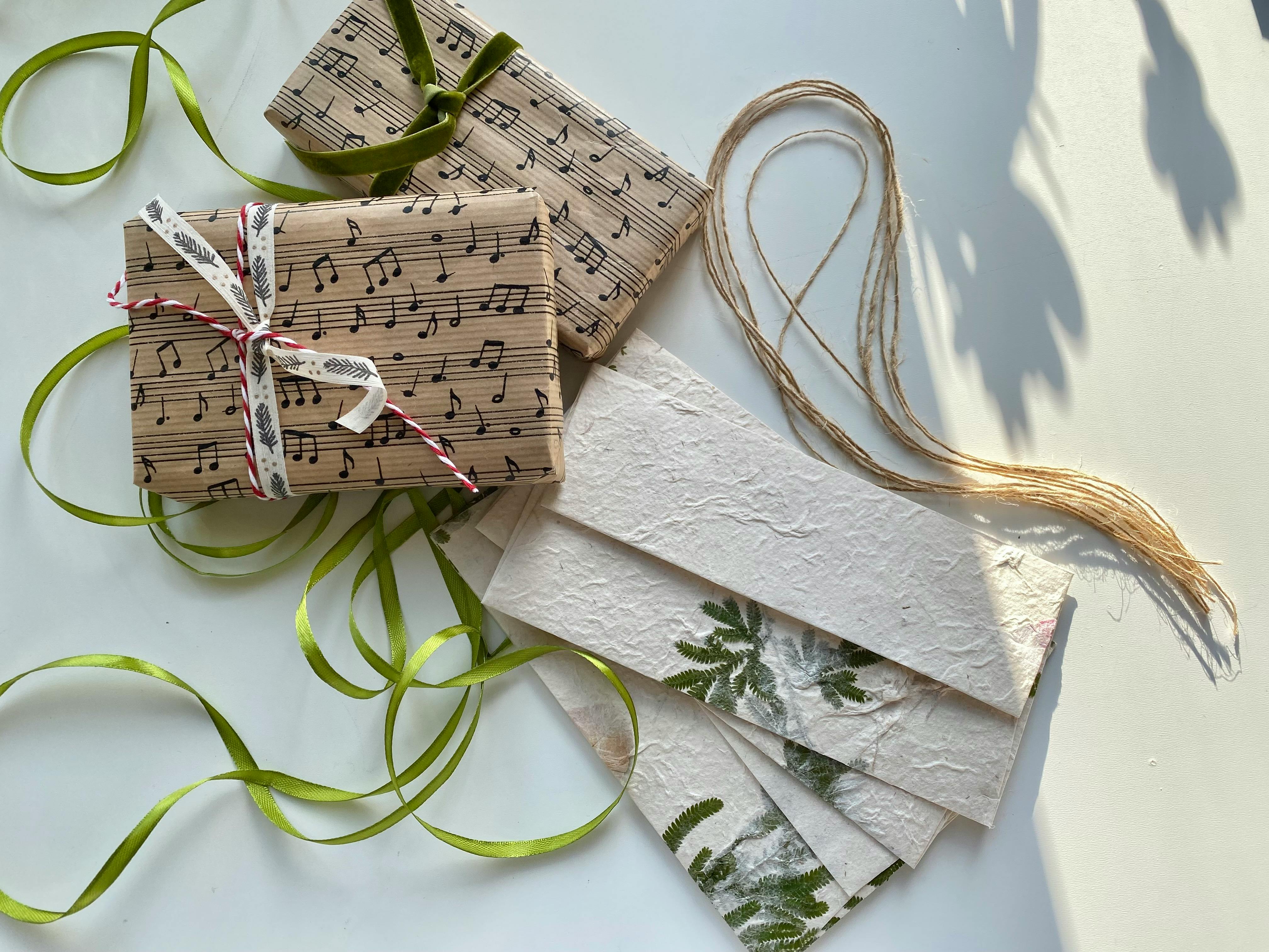 Top view of gifts wrapped in sheet music and eco-friendly materials. Perfect for music lovers.