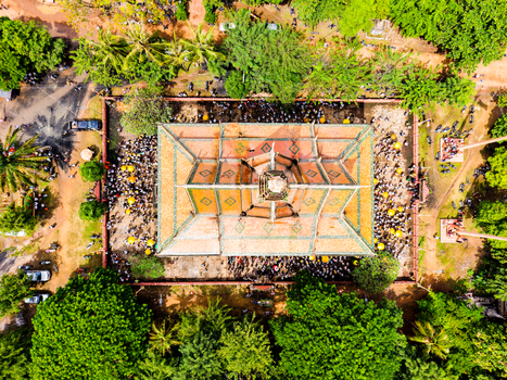A stunning aerial shot of a temple in Cambodia surrounded by vibrant greenery.