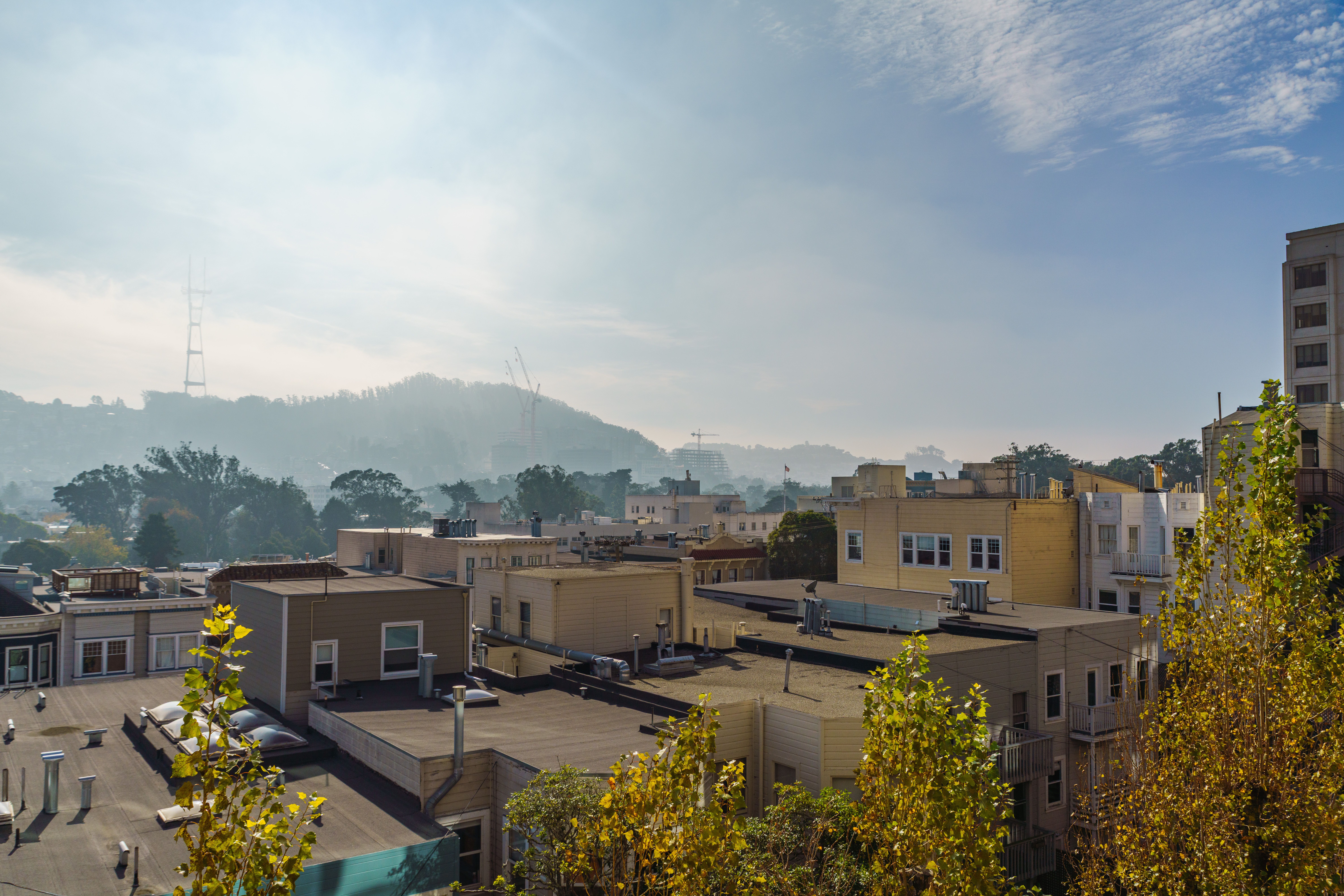 A scenic view of San Francisco rooftops with the iconic Sutro Tower in the background.