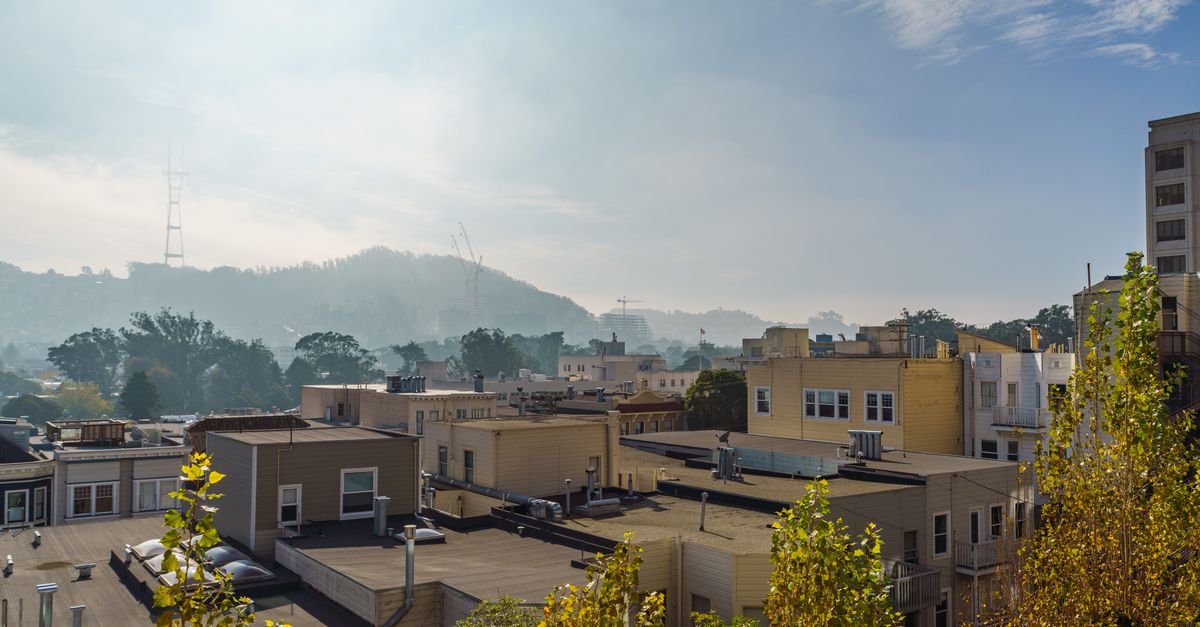 A scenic view of San Francisco rooftops with the iconic Sutro Tower in the background.