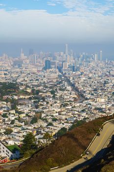 Stunning aerial view of San Francisco's skyline with a scenic road in the foreground.