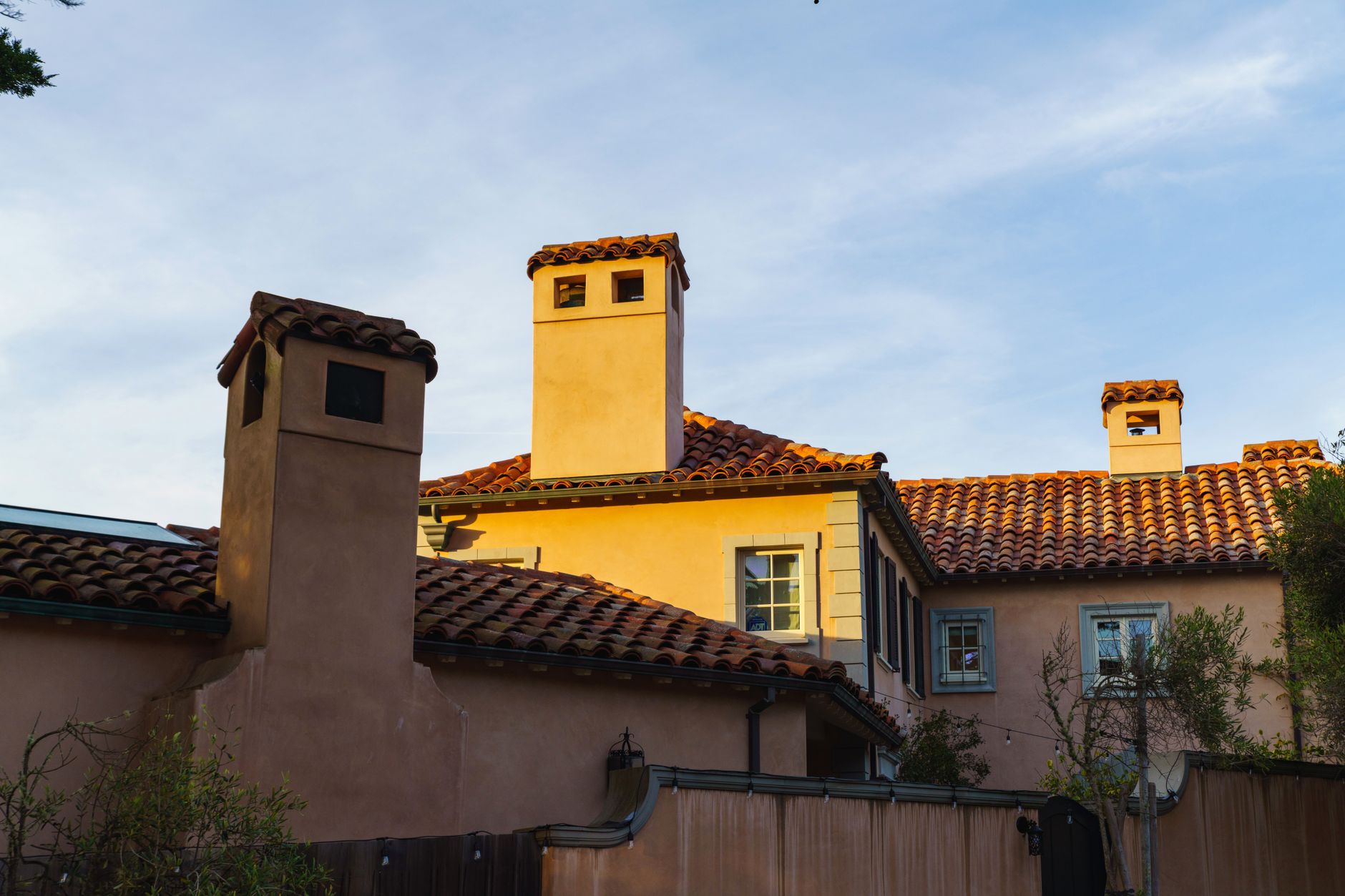 stucco home with terracotta clay tile roof in warm sunset light, typical of Arizona Mediterranean-style architecture