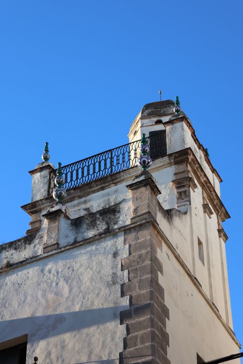 Free Close-up of an architectural tower in El Puerto de Santa María under a blue sky. Stock Photo