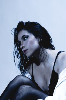 Artistic portrait of a woman in low light, creating an intriguing, dramatic mood.