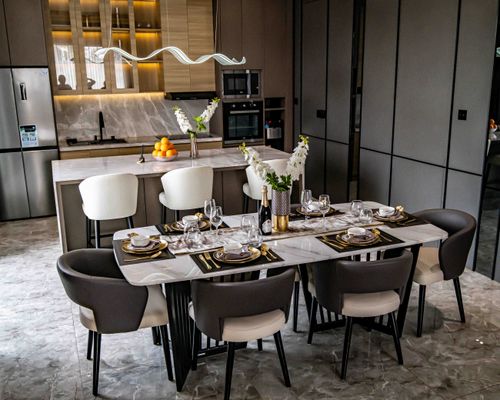 Free Modern dining room with elegant table setting and open kitchen in Jakarta, Indonesia. Stock Photo