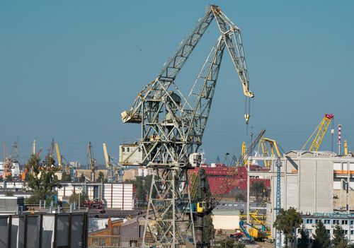 Free Industrial cranes dominate the Gdańsk shipyard skyline, Poland's historic maritime hub. Stock Photo