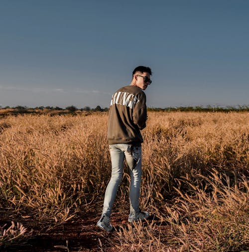 Man Walking on Grass Field