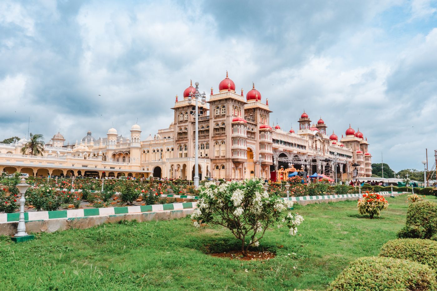 Mysore Palace and its rose gardens under monsoon cloud — representative image