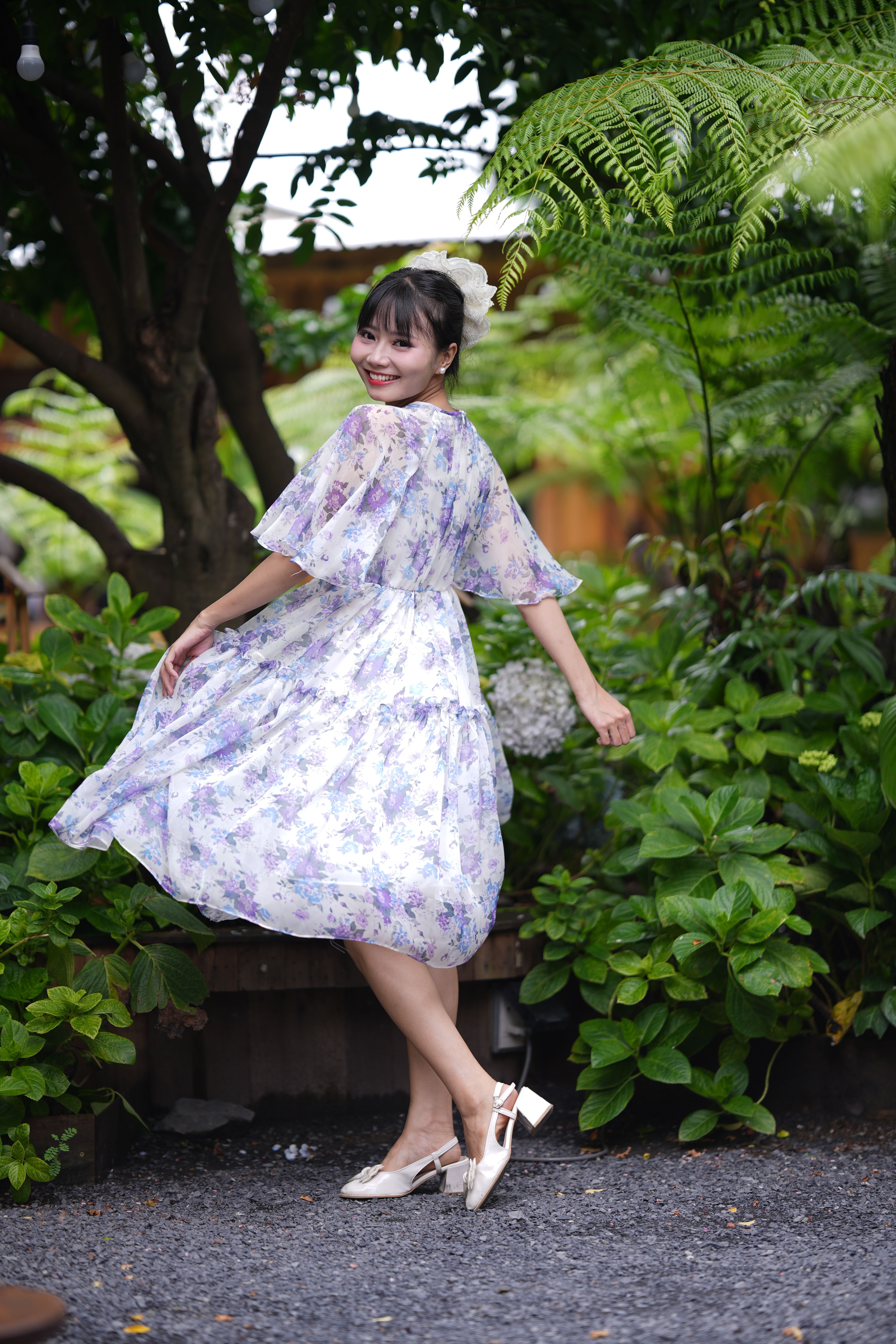 Young Woman Posing in Floral Dress Outdoors · Free Stock Photo