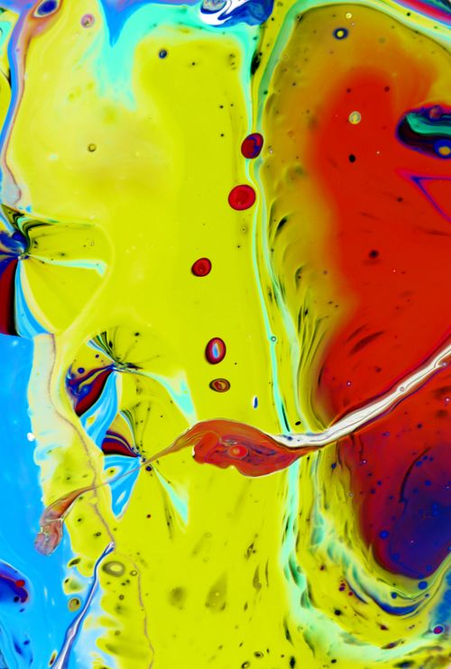Free Dynamic abstract fluid art with vibrant splashes of red, blue, and yellow. Stock Photo