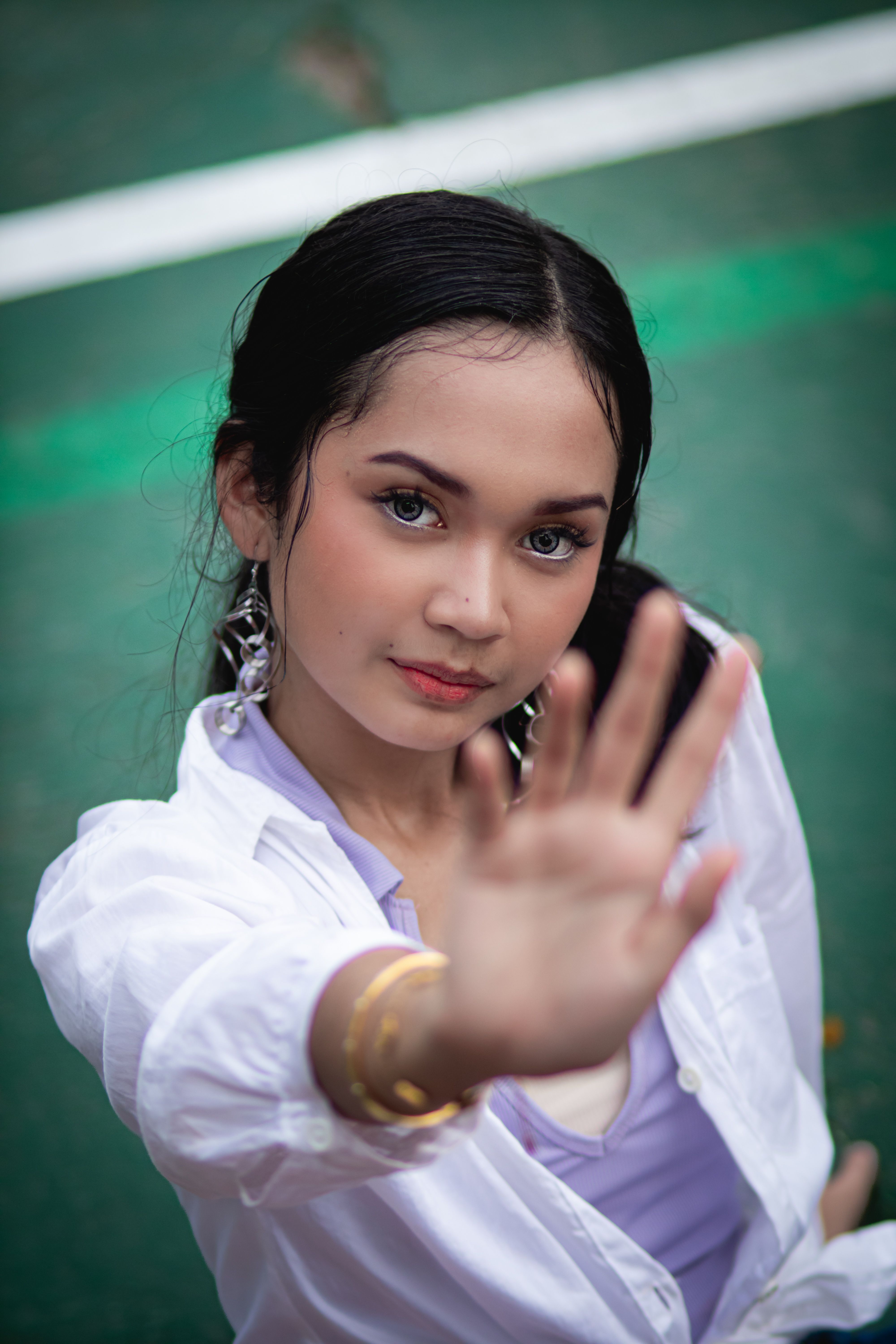 Close-up portrait of a young woman reaching out, showing determination.
