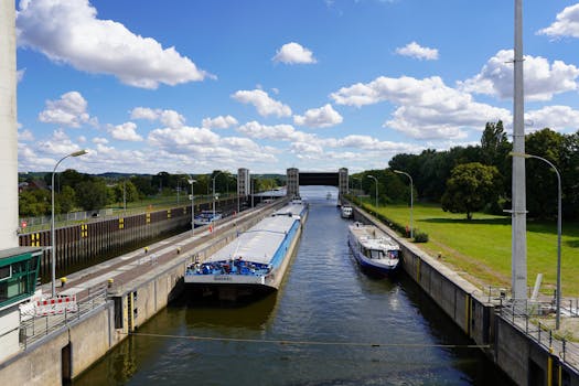 Freight ships passing through Geesthacht canal in Schleswig-Holstein, Germany on a sunny day.