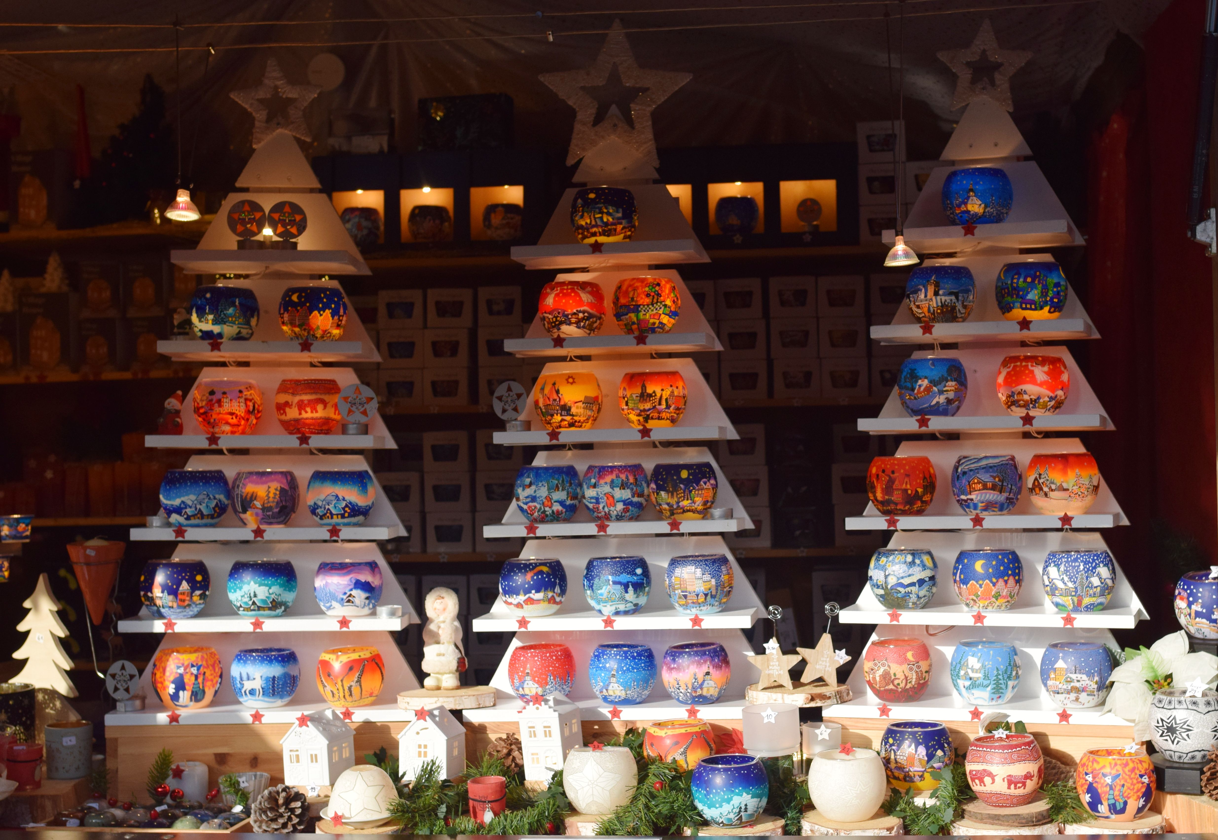 A brightly lit Christmas market stall display in Strasbourg, France