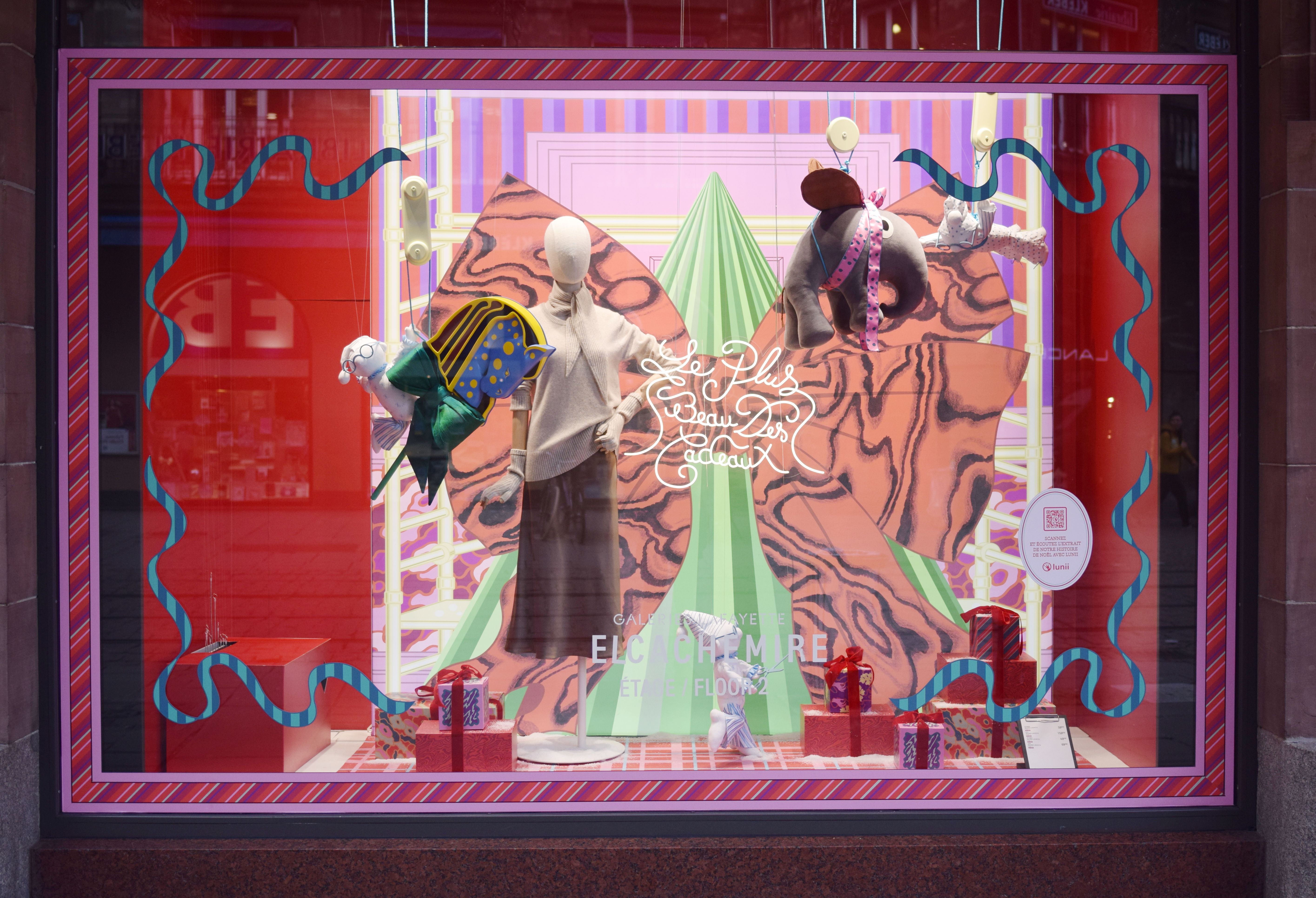 Colorful Strasbourg window display with mannequins and holiday decorations