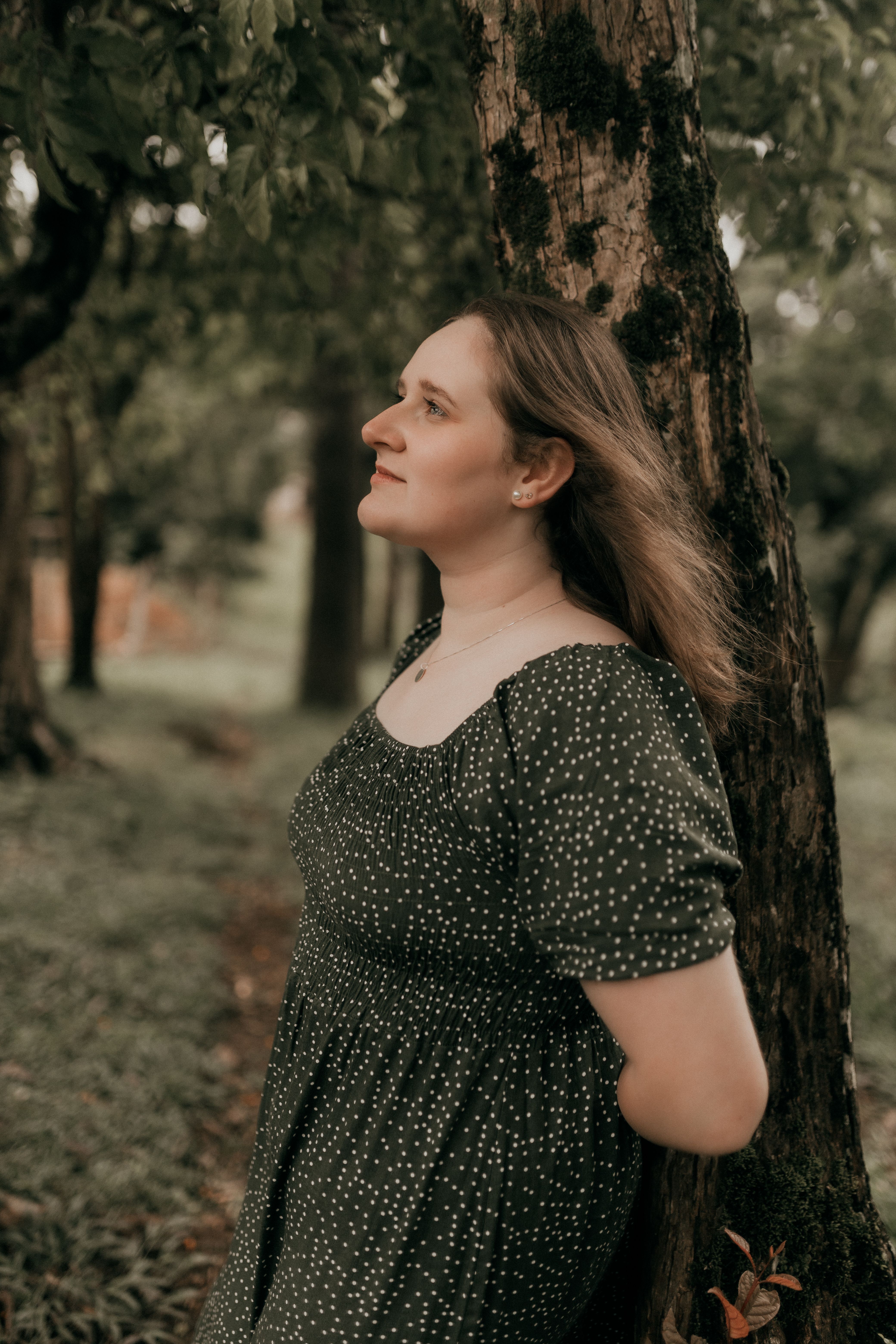 Woman in Black Dress Standing and Posing in Forest · Free Stock Photo