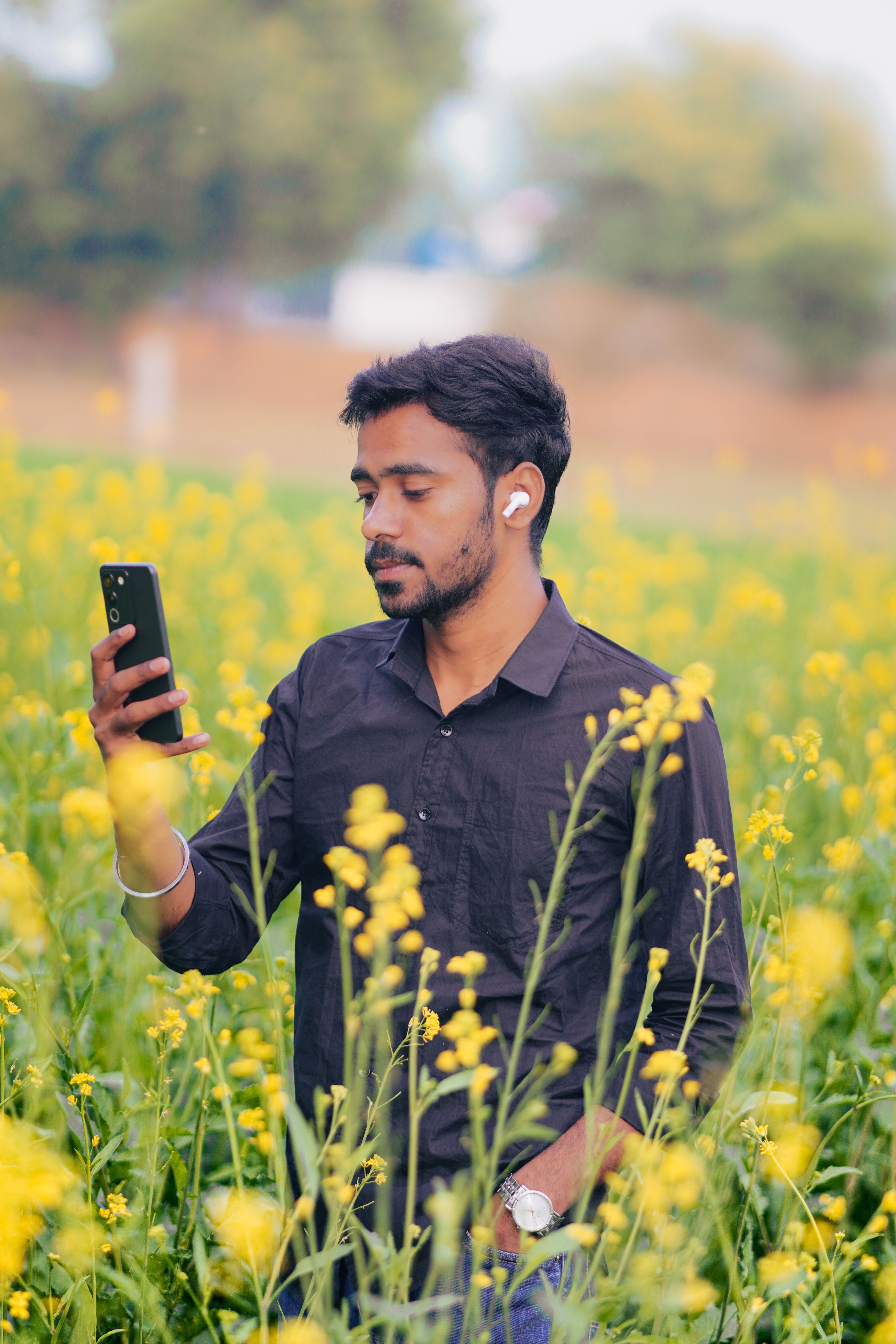 Man in Mustard Field Using Smartphone · Free Stock Photo