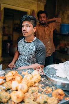 Local street food vendor selling snacks in Varanasi, India, showcasing Indian cuisine.