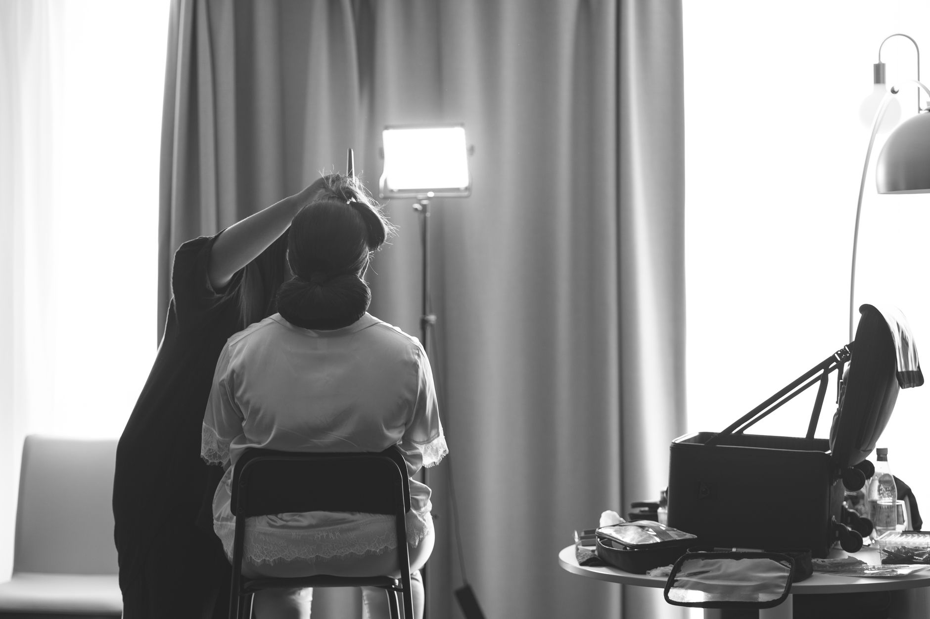 A bride getting her hair styled by a professional before the wedding ceremony.