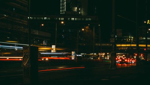 Free Urban night scene featuring busy city street with light trails and buildings. Stock Photo