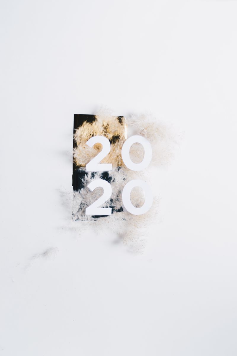 Elegant flat lay of 2020 New Year design with fluffy white background, perfect for celebratory themes.