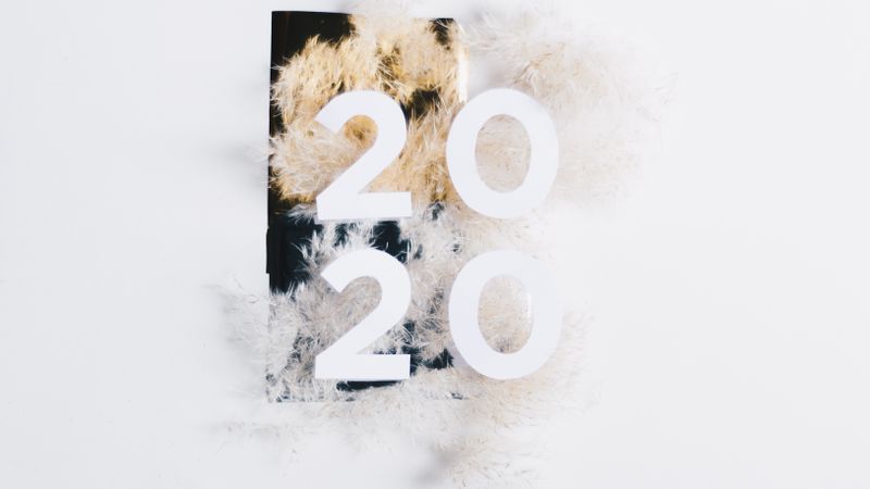 Elegant flat lay of 2020 New Year design with fluffy white background, perfect for celebratory themes.