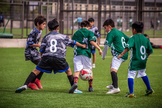 Young soccer players engaging in a dynamic football training session on a Chilean field.
