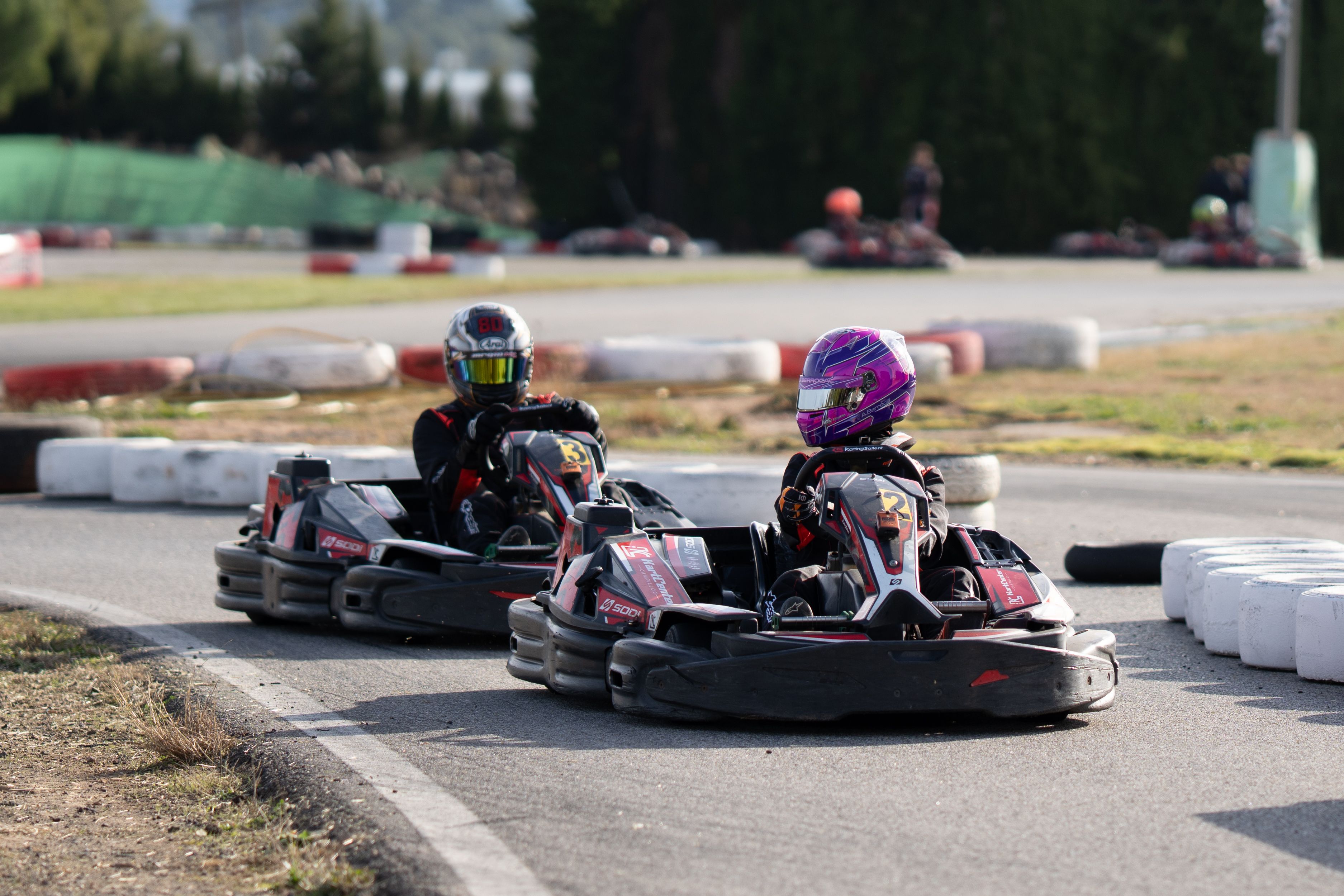 Exciting Go-Kart Race on Outdoor Track · Free Stock Photo