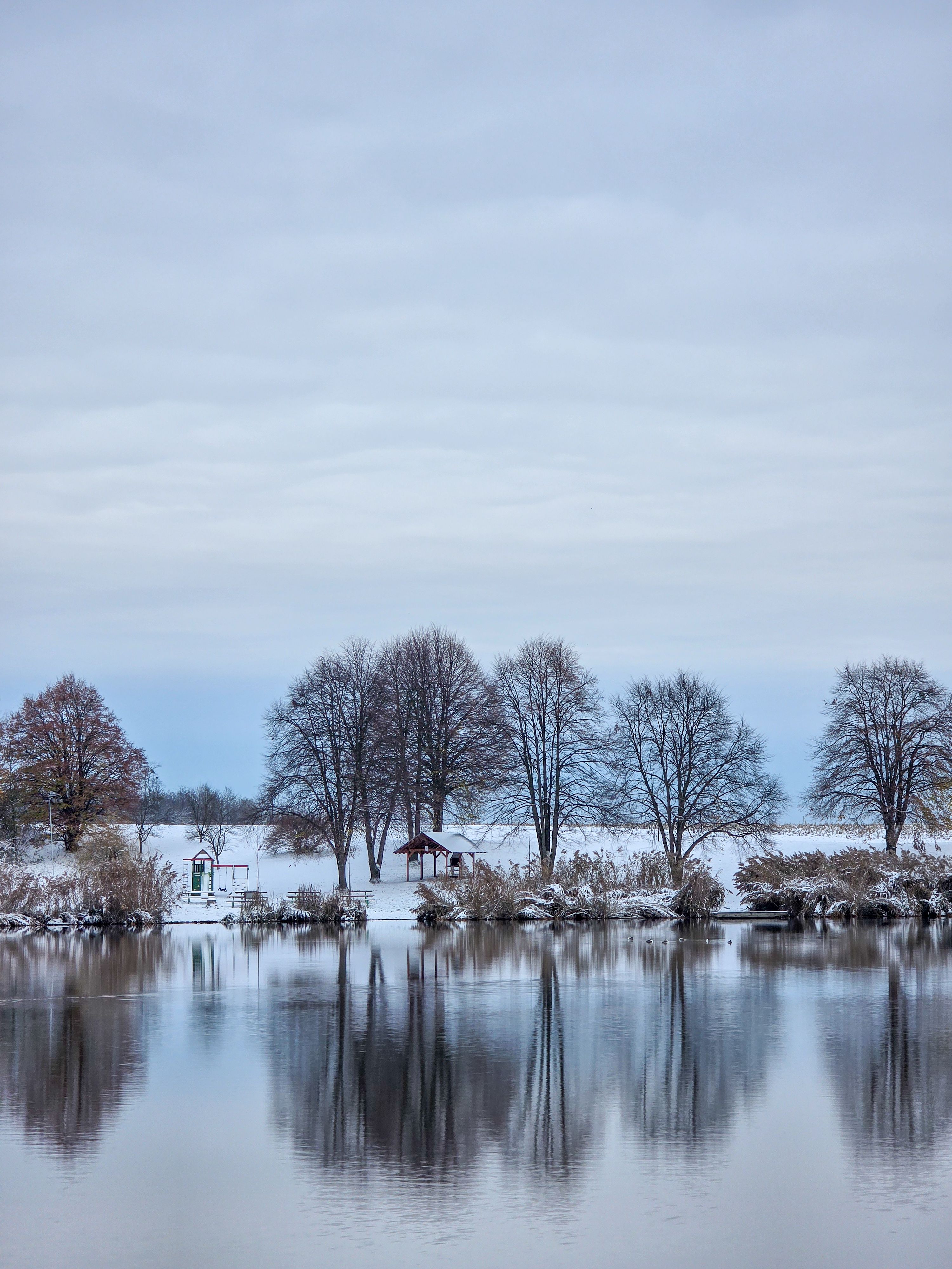 Serene Winter Landscape with Reflective Lake · Free Stock Photo