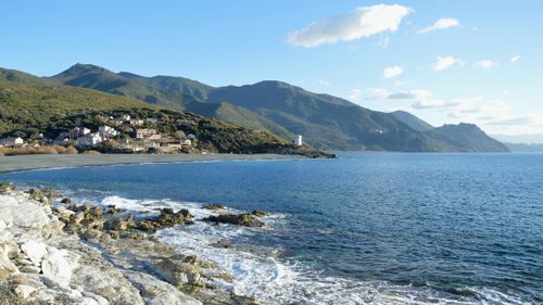 Free Stunning coastal landscape of Ogliastro, Corsica with mountains and a lighthouse. Stock Photo