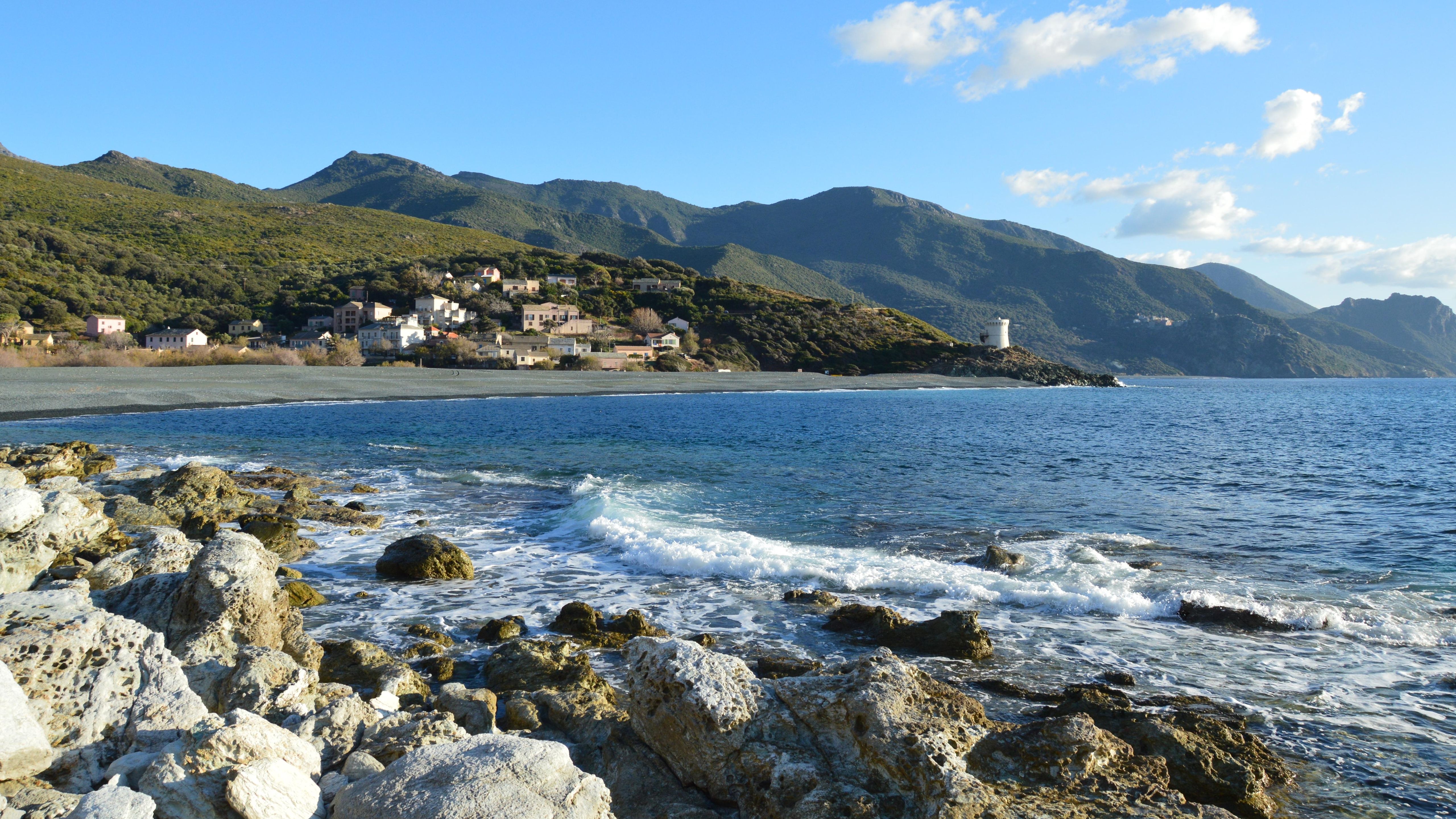 Scenic Ogliastro Beach with Coastal Village View · Free Stock Photo