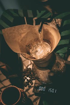 Top view of a pour-over coffee brewing in a cozy setting with warm tones.
