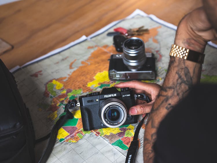 Person Holding Black And Silver Fujifilm Dslr Camera