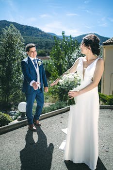 A happy couple enjoying their wedding day outdoors in a scenic location.