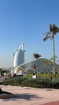 A sunny view of Burj Al Arab and Jumeirah Beach Hotel, showcasing Dubai's modern architecture.