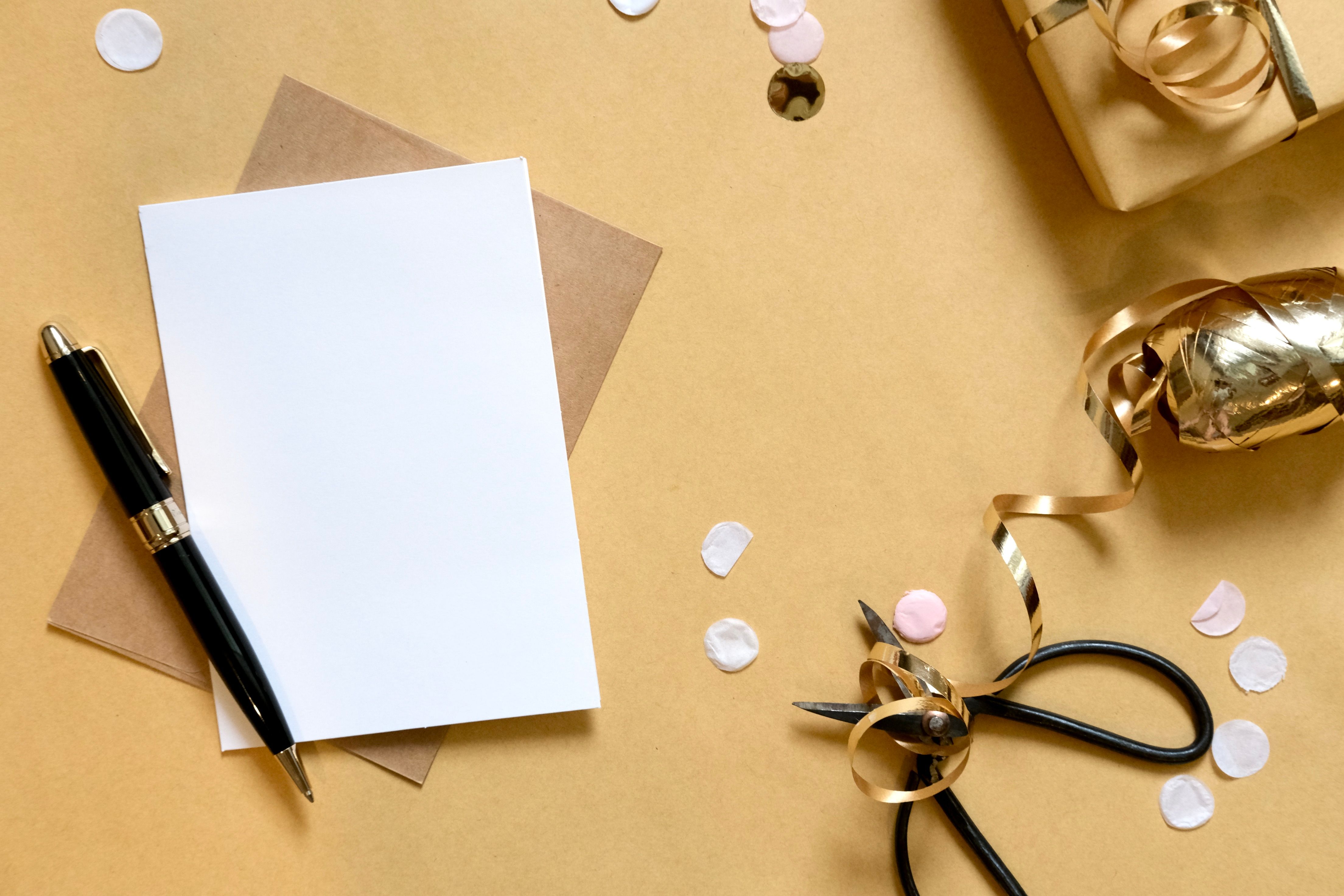 Gift wrapping flat lay with scissors, ribbon, and card
