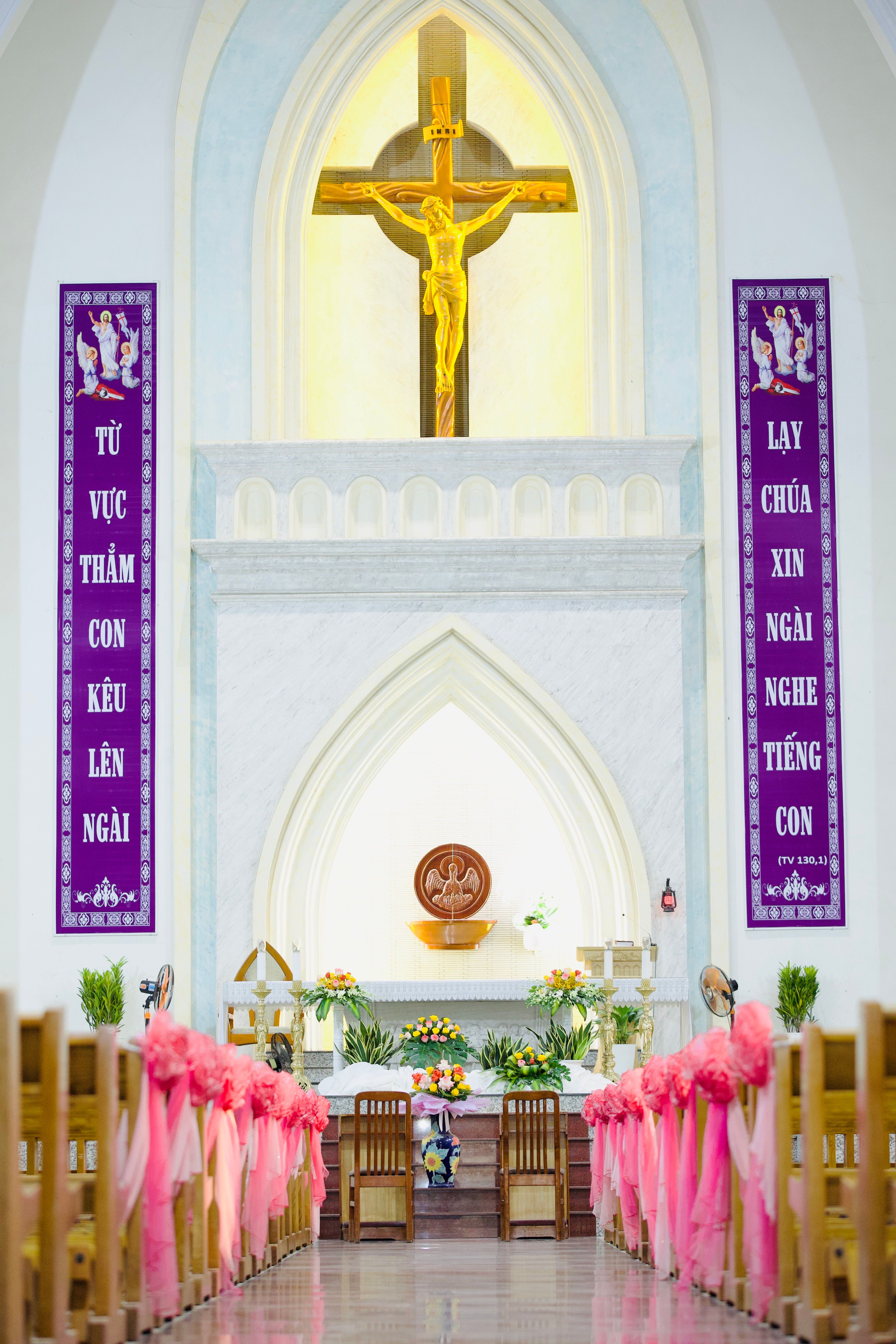 Beautiful church interior with a golden crucifix above the altar.
