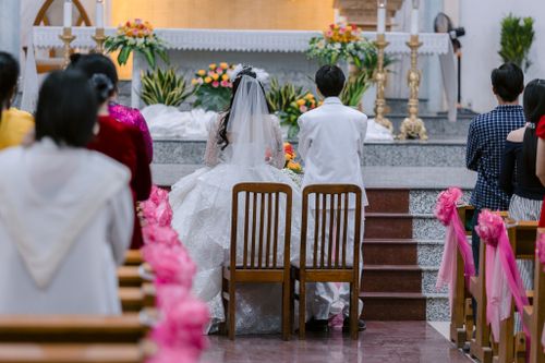 Free Bride and groom in traditional attire at a beautiful church wedding ceremony. Stock Photo