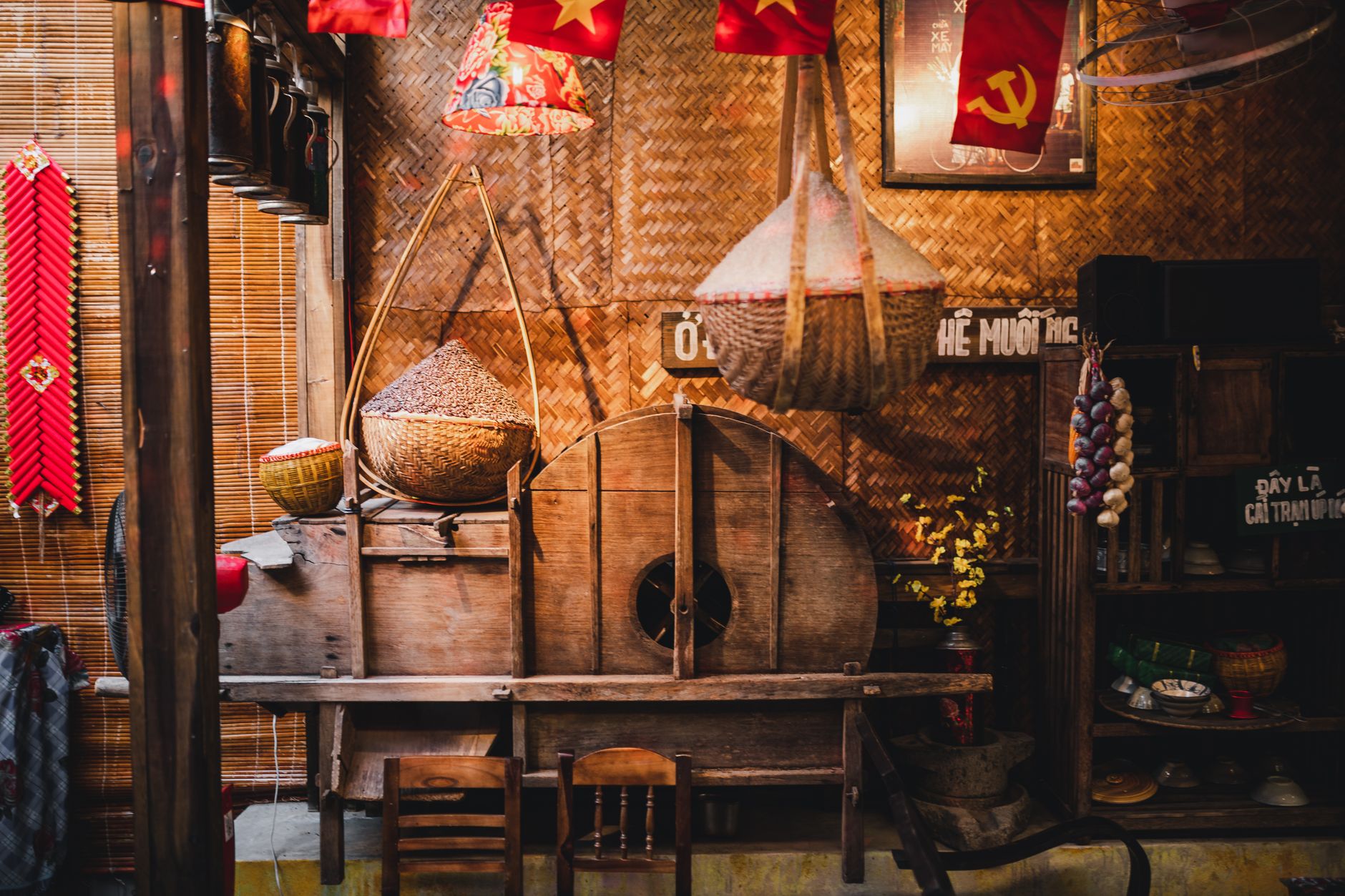 Cozy Vietnamese interior with traditional decor, baskets, and cultural elements in warm lighting.