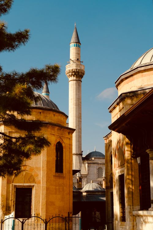 Free Beautiful minaret against a blue sky amidst historic buildings in daylight. Stock Photo