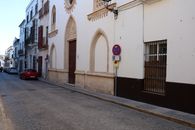 Charming historic street with classic Andalusian architecture in El Puerto de Santa María, Spain.