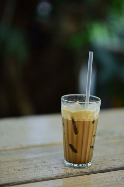 Free Chilled iced coffee with cream served in an outdoor setting, perfect for summer refreshments. Stock Photo