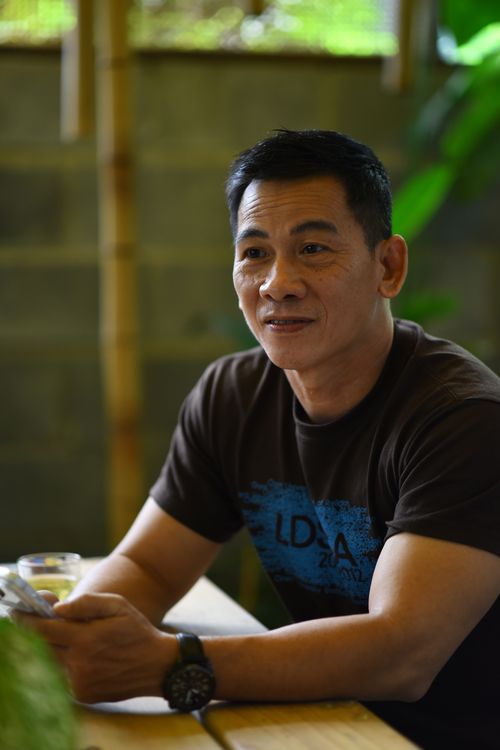 Free A relaxed Asian man sitting indoors, enjoying a calm moment. Stock Photo