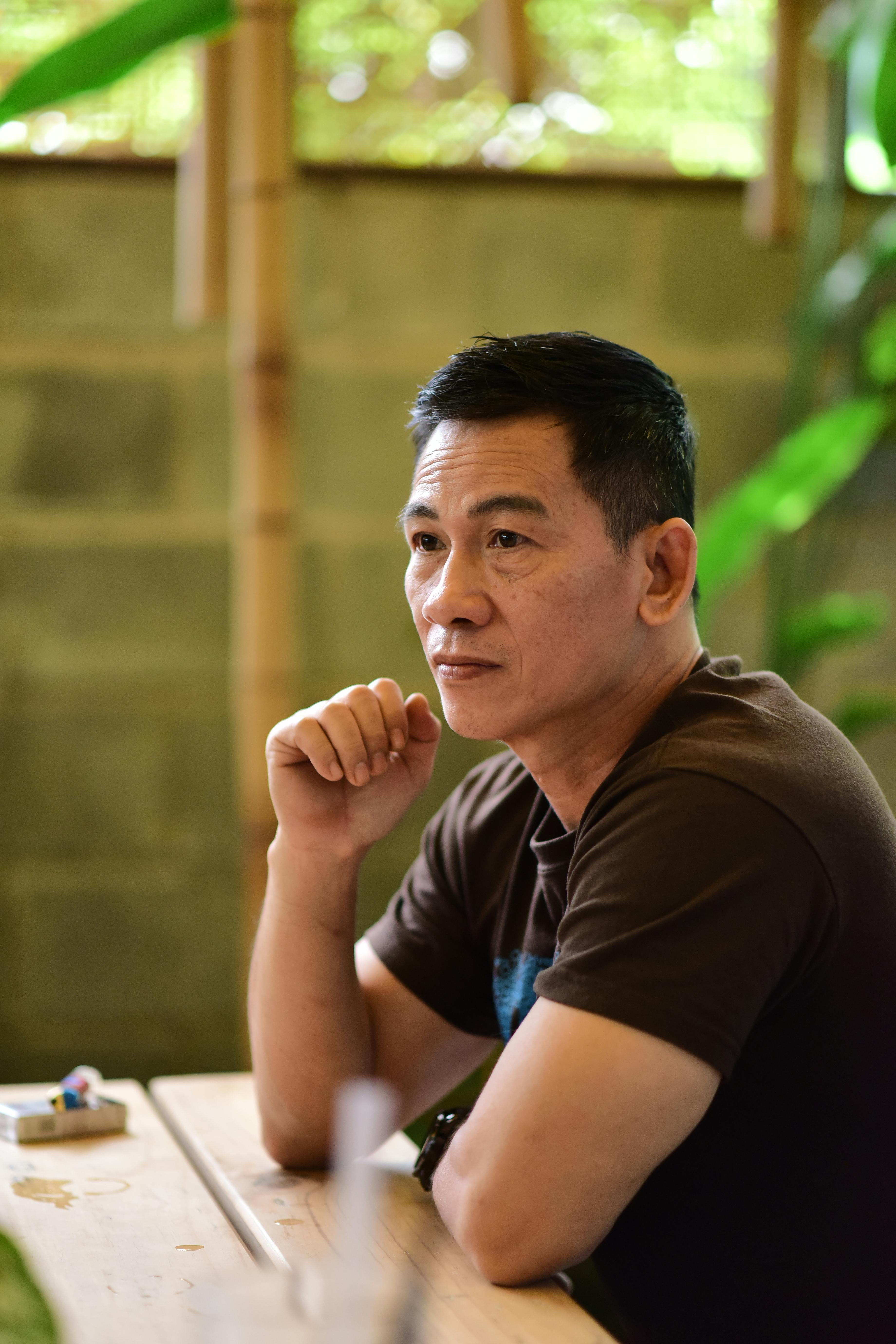 Thoughtful man sitting indoors, lost in contemplation at a cafe.
