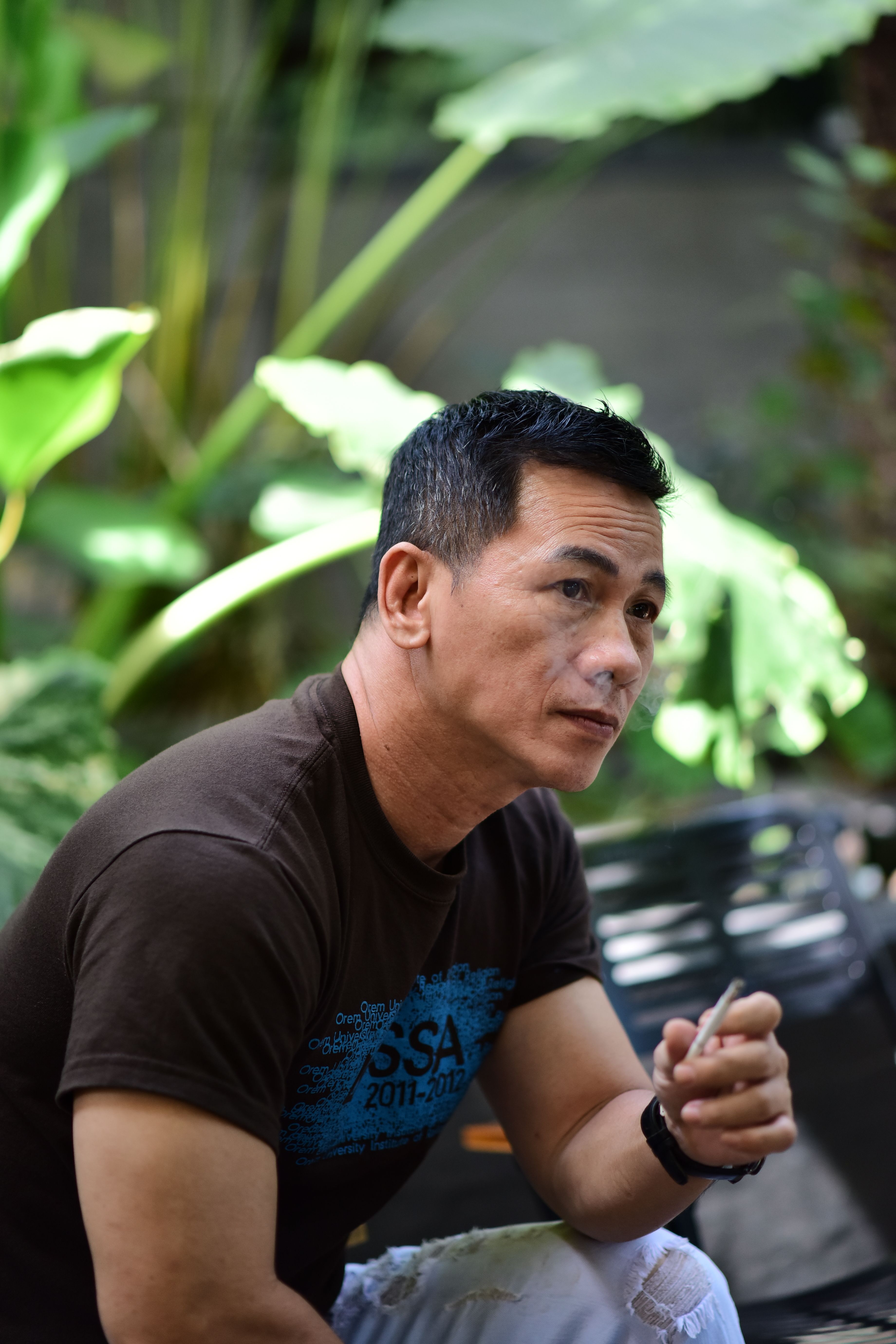 Thoughtful Man Relaxing Outdoors with Cigarette