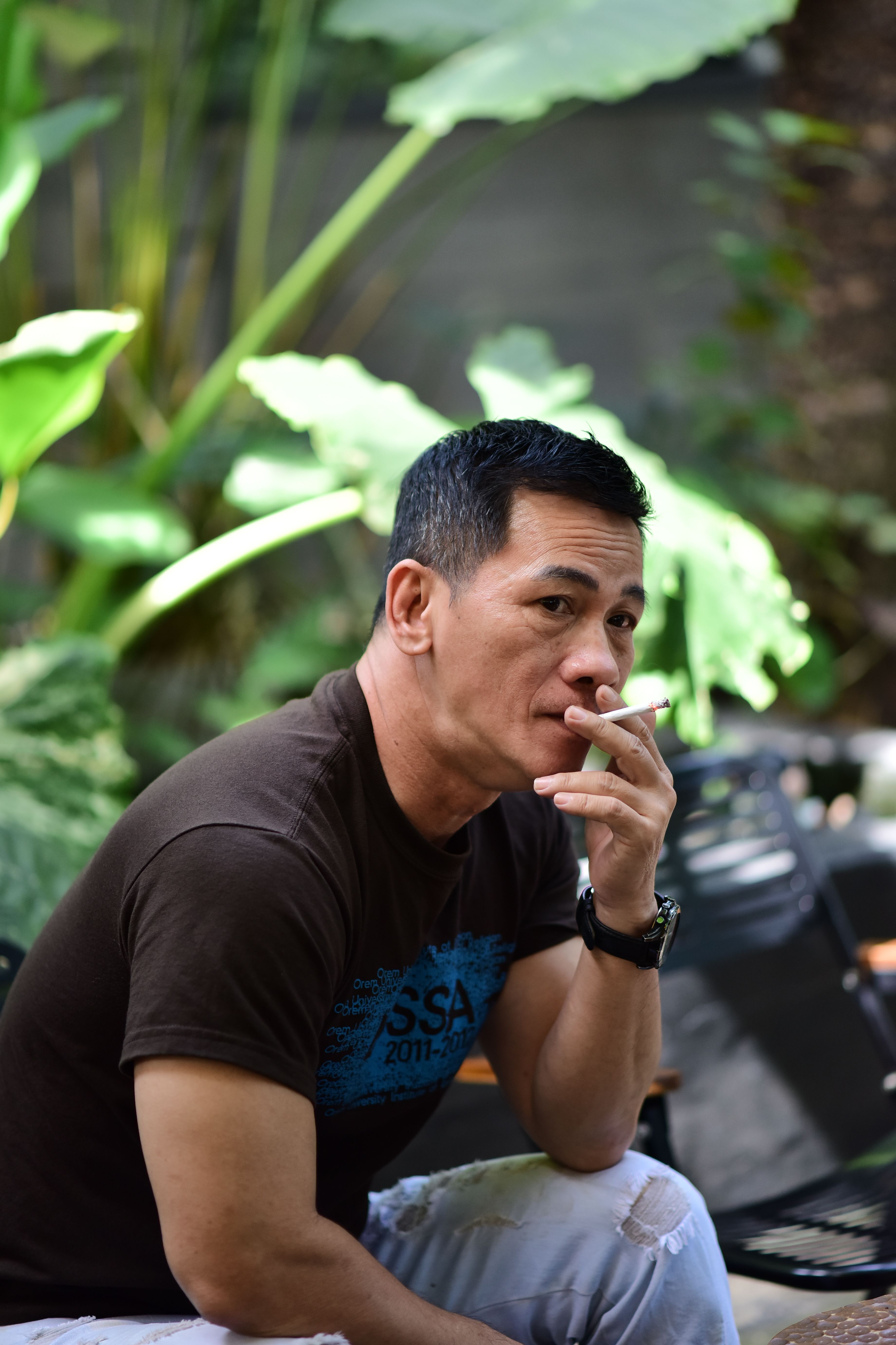 Contemplative Man Relaxing Outdoors with Cigarette