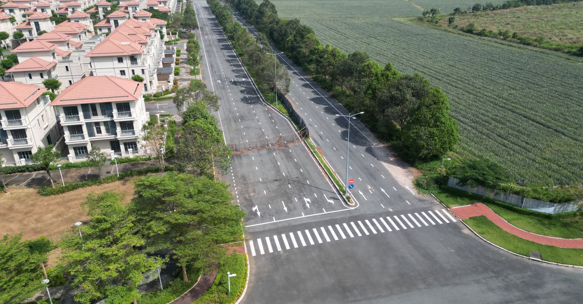 Aerial view of luxury villas and a road in Dong Nai, Vietnam, capturing modern real estate.