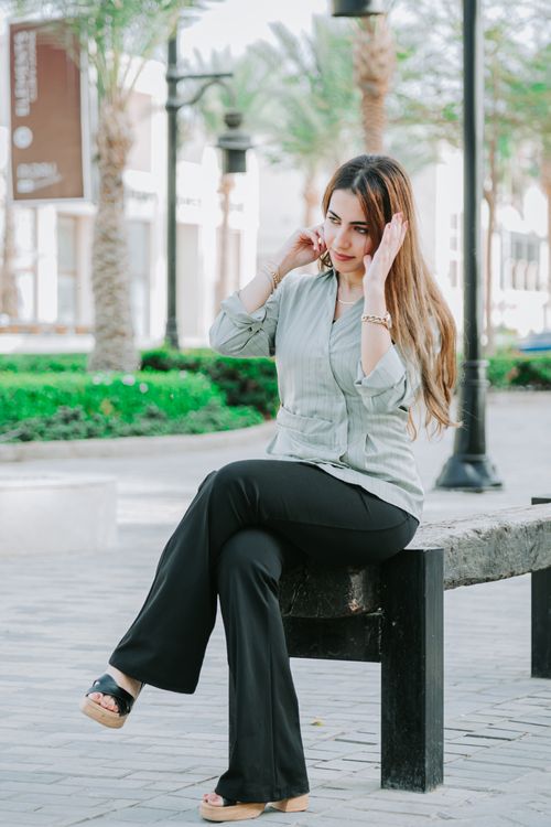 Young Woman Relaxing on Park Bench Outdoors · Free Stock Photo
